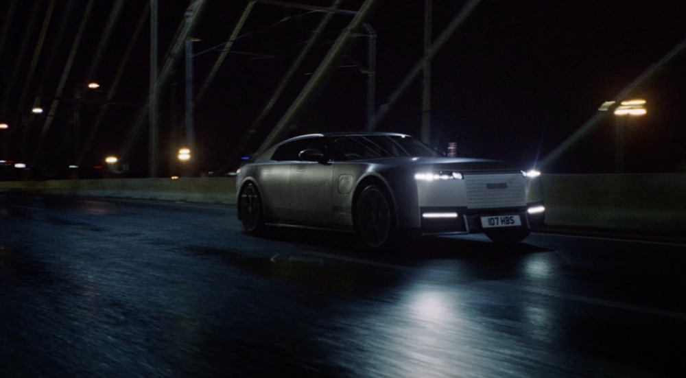 Reference film still: a car crossing a bridge at night
