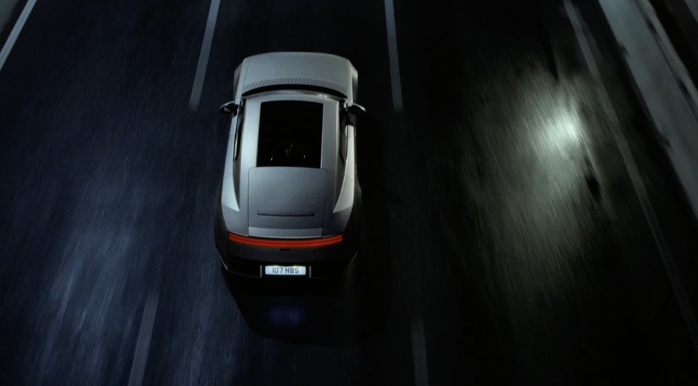 Reference film still: a car filmed from above at speed