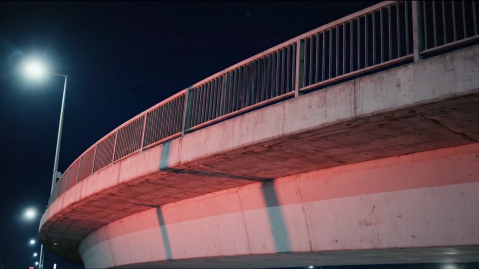 Veo 3.1 footage: the underside of a flyover washed with red light